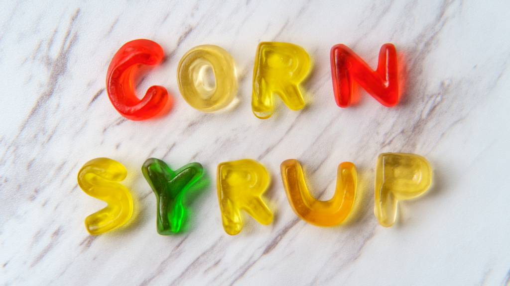 Picture of multi coloured gelatine sweets spelling the words 'corn syrup'.